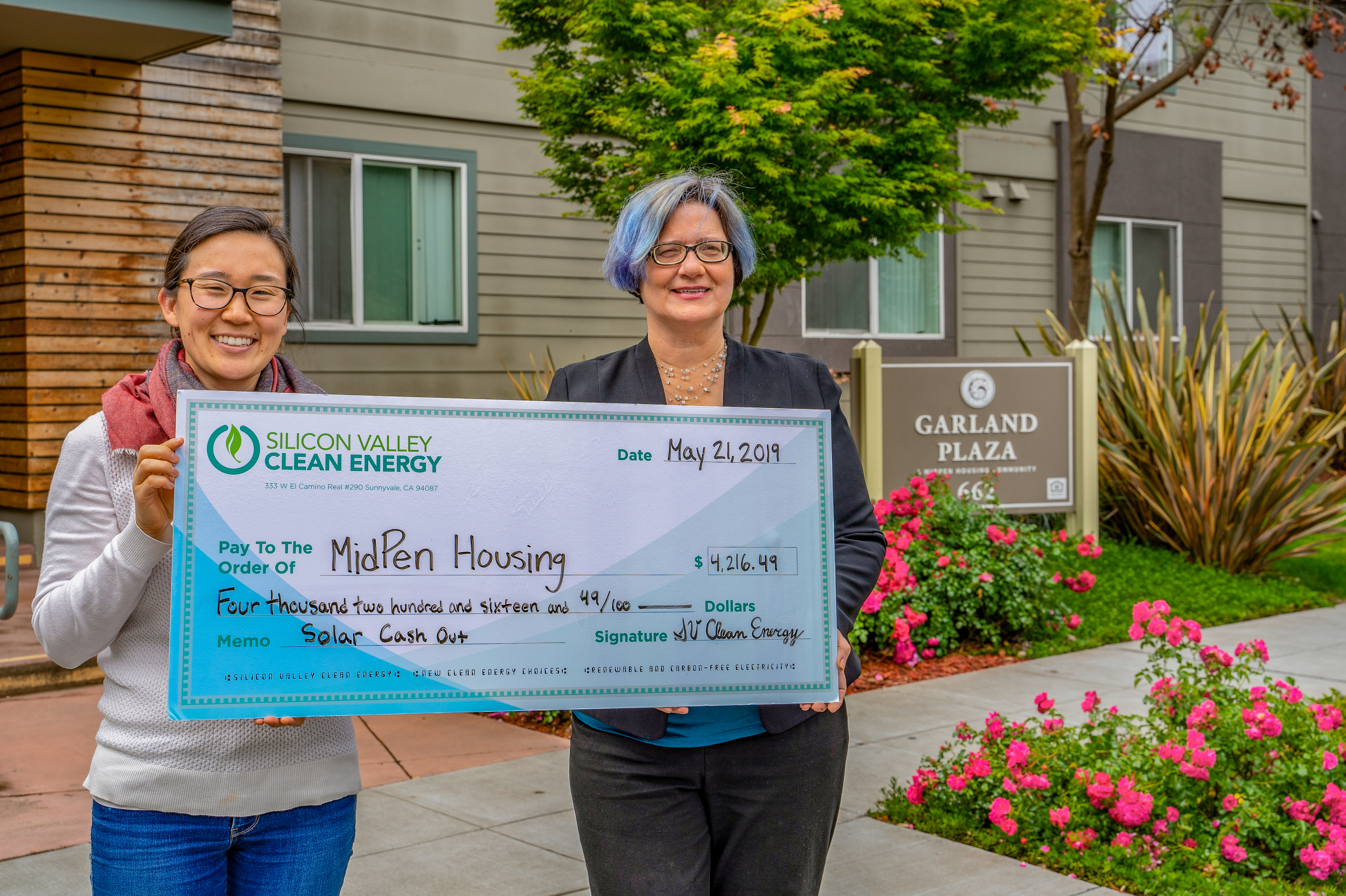 Sunnyvale Councilmember and MidPen Housing Rep Holding Giant Check