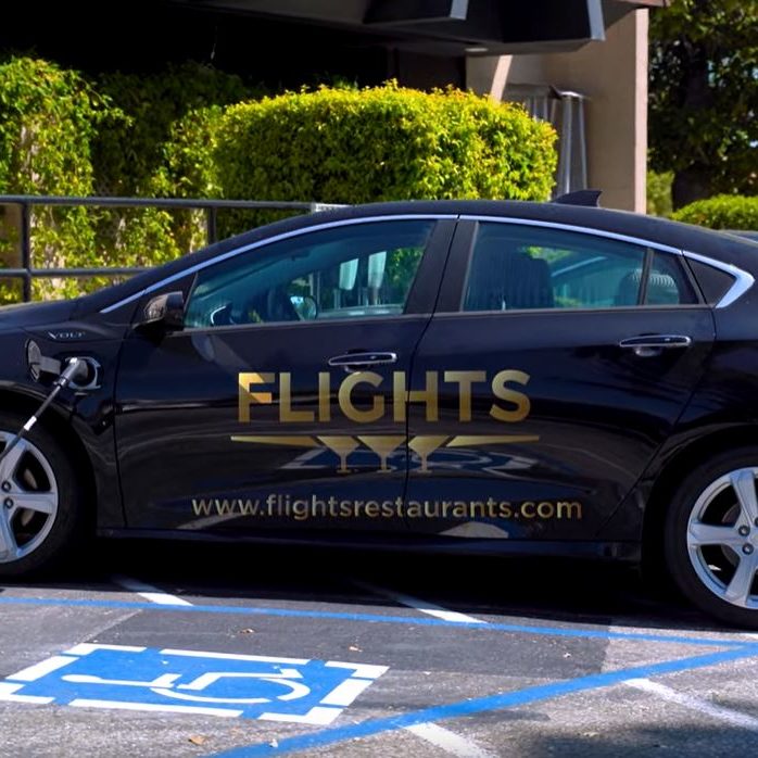 electric car plugged in with Flights logo on the car