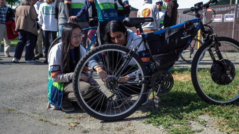 two students working on their electric bike