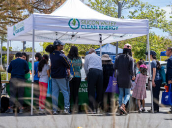 people at a Silicon Valley Clean Energy booth at a community event