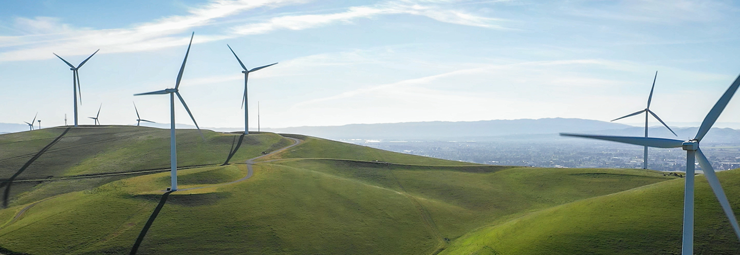 Landscape photo of rolling hills with windmills