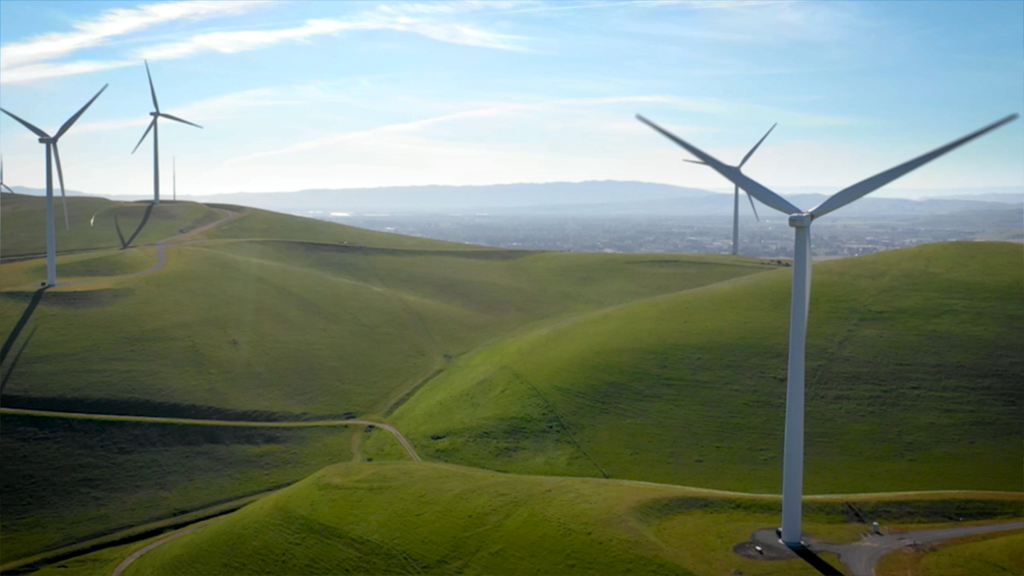Landscape photo of rolling hills with windmills