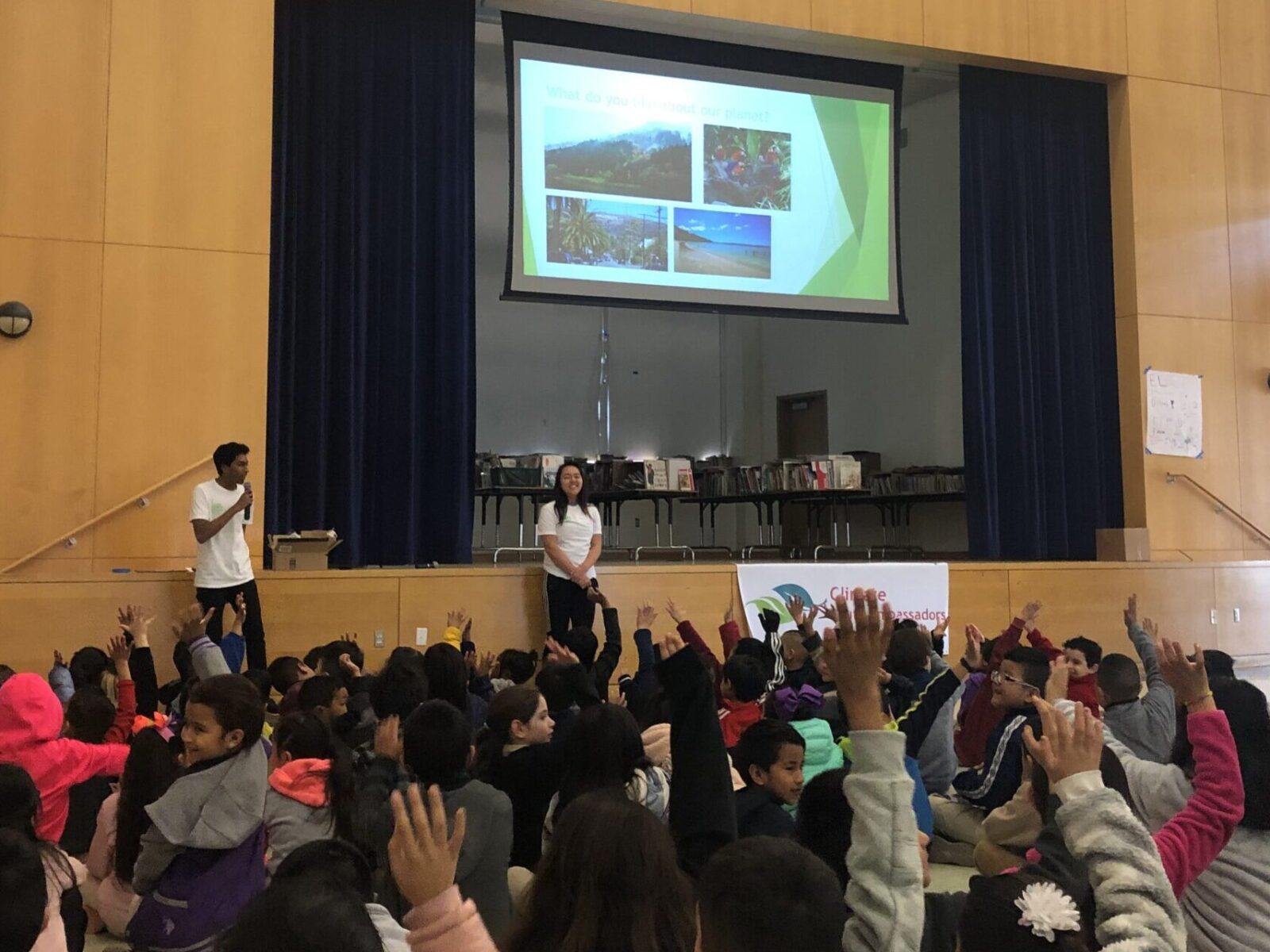 Climate Youth Ambassadors presenting to large group of elementary school students
